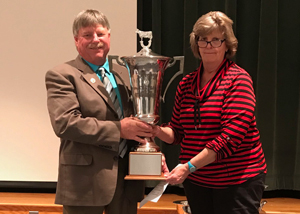 Nancy Keith presents awards to Corey Lutz for winning the state’s lifetime production contest for milk and fat. Piedmont Avery Lindsey won the awards with lifetime production of 246,992 lbs. milk and 10,154 lbs. fat in 12 lactations.