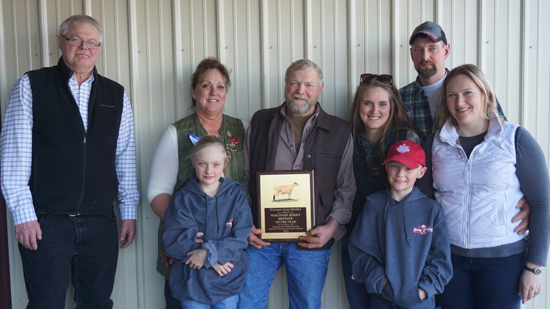 	NAJ Director Walter Owens presents Darryl Young (center holding plaque) with the Wisconsin Senior Breeder Award. Also pictured in the back left to right are Young’s wife, Barb Young, granddaughter Riah Young, and son, Brent. Front is granddaughter, Zanna, grandson, Stellan, and daughter-in-law Tara. 